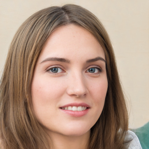 Joyful white young-adult female with long  brown hair and green eyes