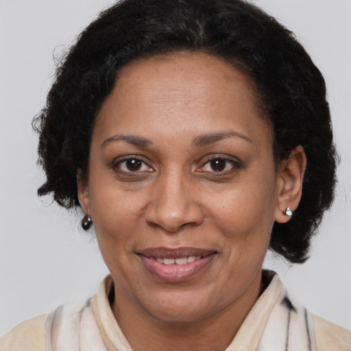 Joyful latino adult female with short  brown hair and brown eyes