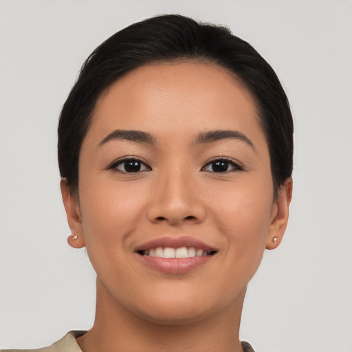 Joyful asian young-adult female with short  brown hair and brown eyes