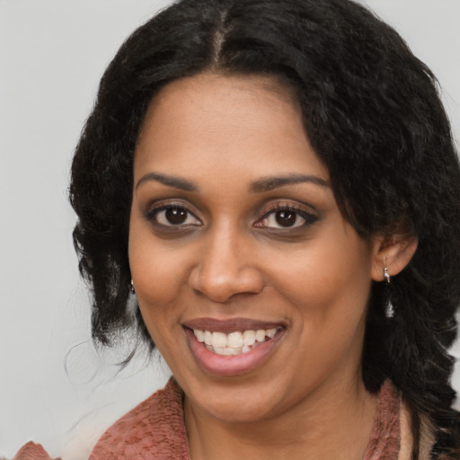 Joyful black young-adult female with medium  black hair and brown eyes