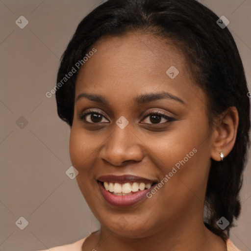 Joyful black young-adult female with long  brown hair and brown eyes