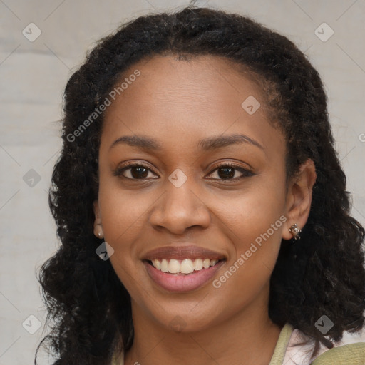 Joyful black young-adult female with long  brown hair and brown eyes