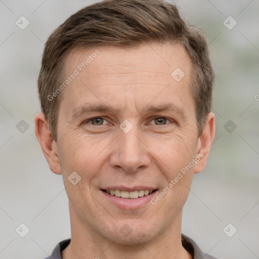 Joyful white adult male with short  brown hair and grey eyes