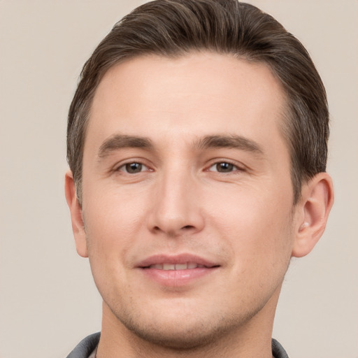 Joyful white young-adult male with short  brown hair and brown eyes