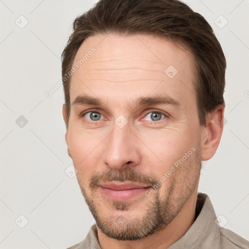 Joyful white adult male with short  brown hair and grey eyes