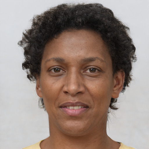 Joyful latino adult female with short  brown hair and brown eyes