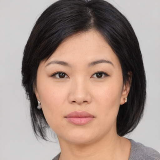 Neutral asian young-adult female with medium  black hair and brown eyes