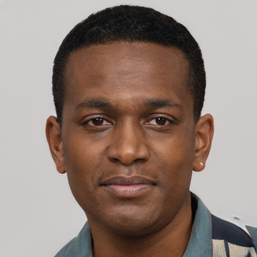 Joyful latino young-adult male with short  brown hair and brown eyes
