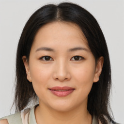 Joyful asian young-adult female with medium  brown hair and brown eyes