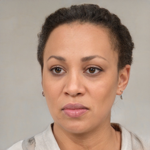 Joyful latino adult female with short  brown hair and brown eyes