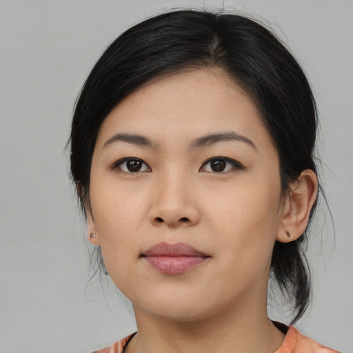 Joyful asian young-adult female with medium  black hair and brown eyes