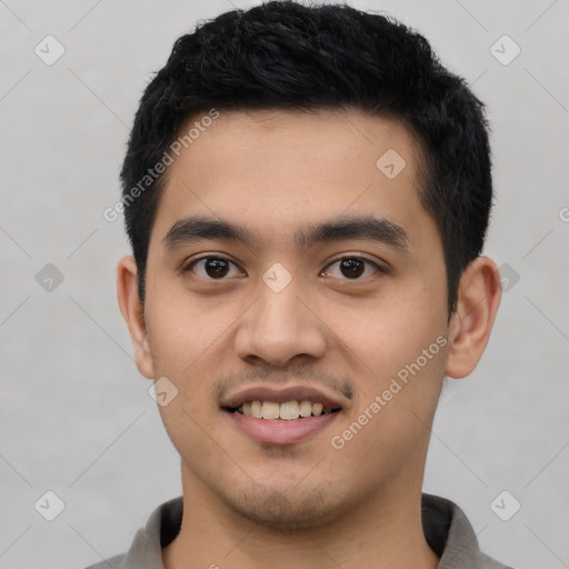 Joyful latino young-adult male with short  black hair and brown eyes