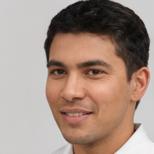 Joyful white young-adult male with short  black hair and brown eyes