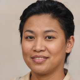 Joyful latino young-adult female with medium  brown hair and brown eyes