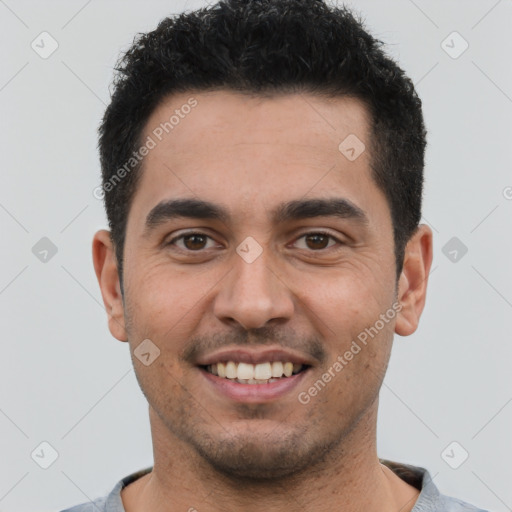 Joyful latino young-adult male with short  brown hair and brown eyes