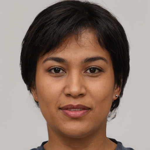 Joyful asian young-adult female with medium  brown hair and brown eyes