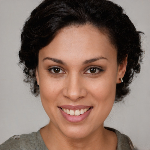 Joyful latino young-adult female with medium  brown hair and brown eyes