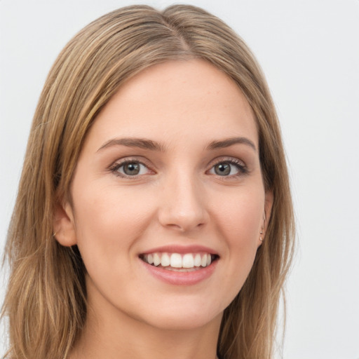 Joyful white young-adult female with long  brown hair and green eyes