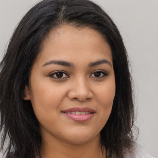 Joyful asian young-adult female with long  brown hair and brown eyes