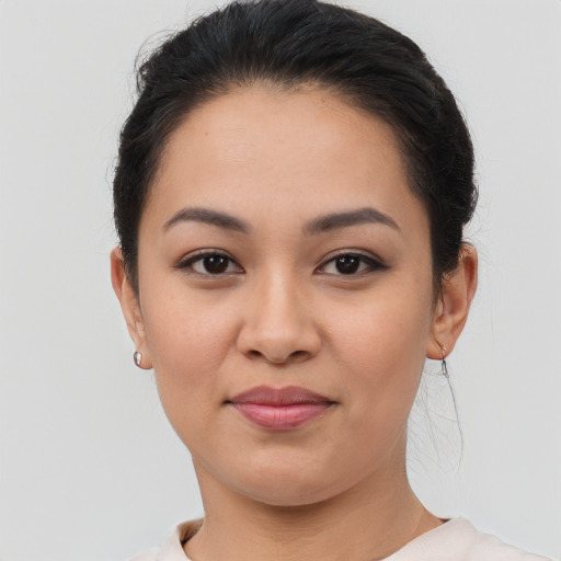 Joyful latino young-adult female with short  brown hair and brown eyes
