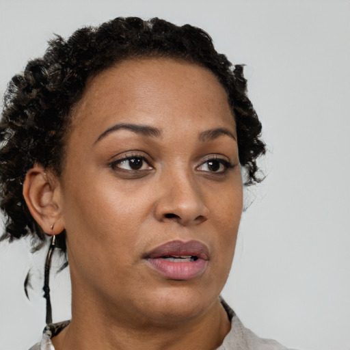 Joyful black adult female with short  brown hair and brown eyes