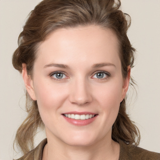 Joyful white young-adult female with medium  brown hair and blue eyes