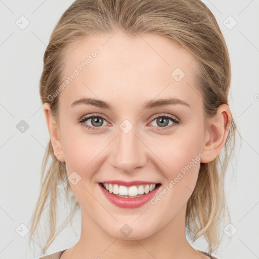 Joyful white young-adult female with medium  brown hair and blue eyes