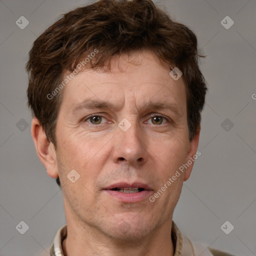 Joyful white adult male with short  brown hair and grey eyes