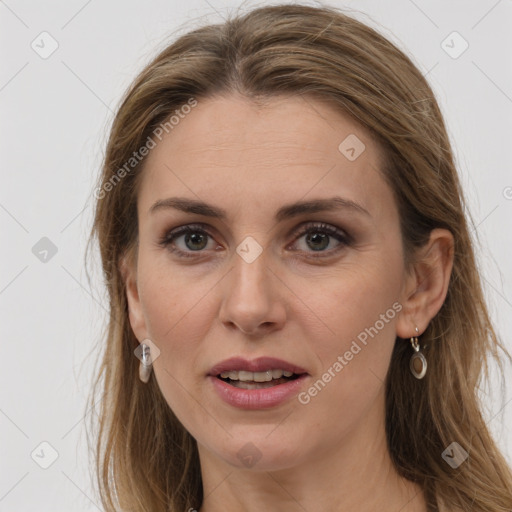 Joyful white adult female with long  brown hair and grey eyes