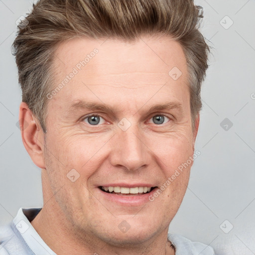 Joyful white adult male with short  brown hair and grey eyes