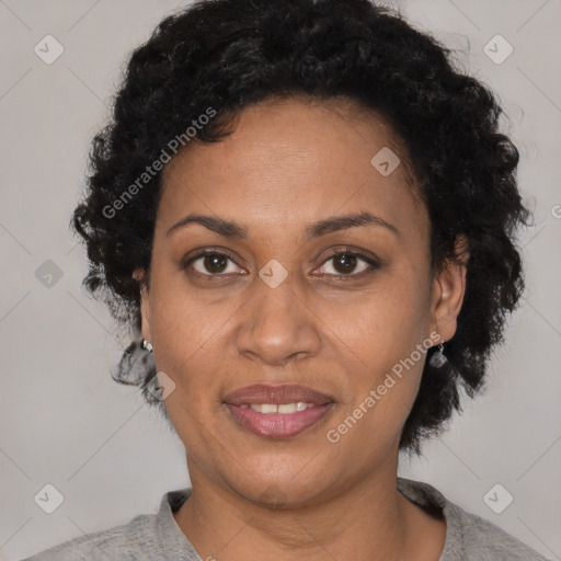 Joyful black adult female with short  black hair and brown eyes