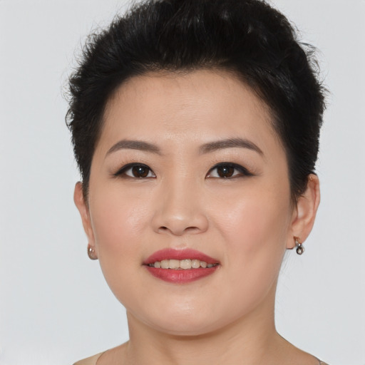 Joyful asian young-adult female with short  brown hair and brown eyes