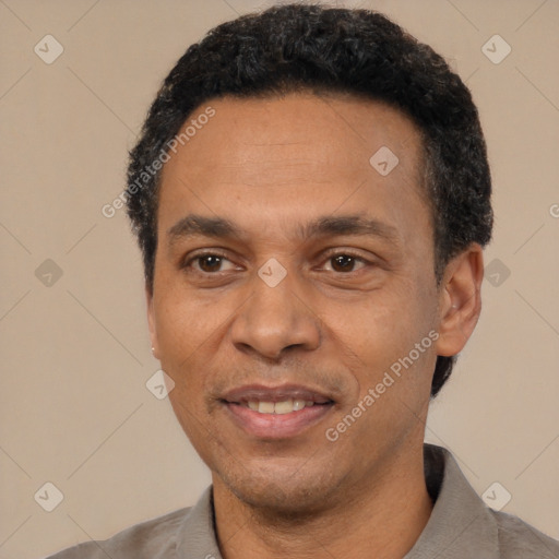 Joyful latino adult male with short  black hair and brown eyes