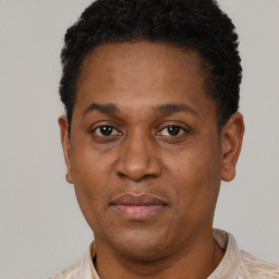 Neutral latino adult male with short  black hair and brown eyes