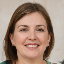 Joyful white adult female with medium  brown hair and grey eyes