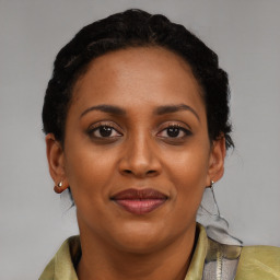 Joyful black young-adult female with short  brown hair and brown eyes