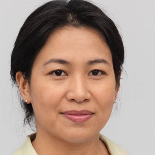 Joyful asian adult female with medium  brown hair and brown eyes