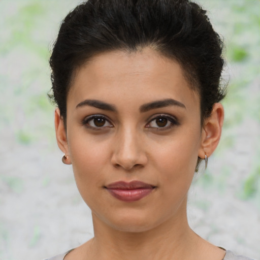 Joyful latino young-adult female with short  brown hair and brown eyes