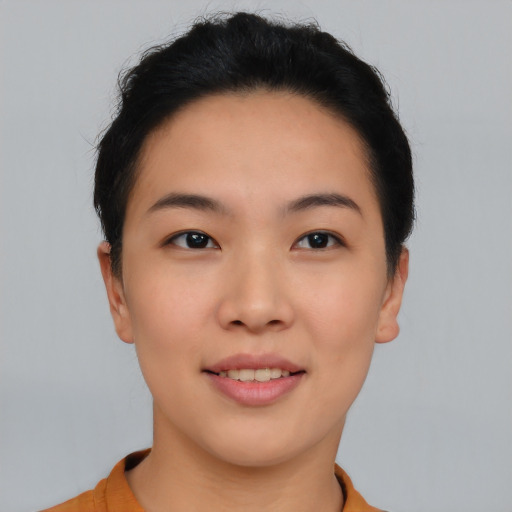 Joyful asian young-adult female with short  black hair and brown eyes