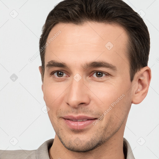 Joyful white young-adult male with short  brown hair and brown eyes