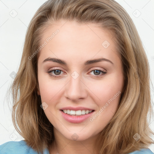 Joyful white young-adult female with long  brown hair and blue eyes