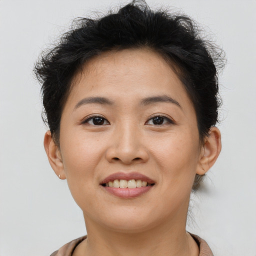 Joyful asian young-adult female with short  brown hair and brown eyes