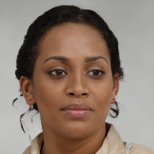 Joyful black young-adult female with medium  brown hair and brown eyes