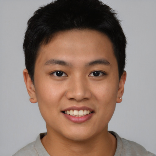Joyful asian young-adult male with short  brown hair and brown eyes