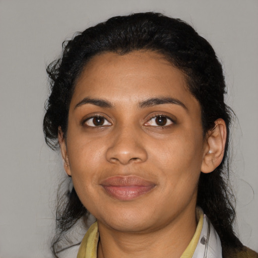 Joyful black young-adult female with medium  black hair and brown eyes