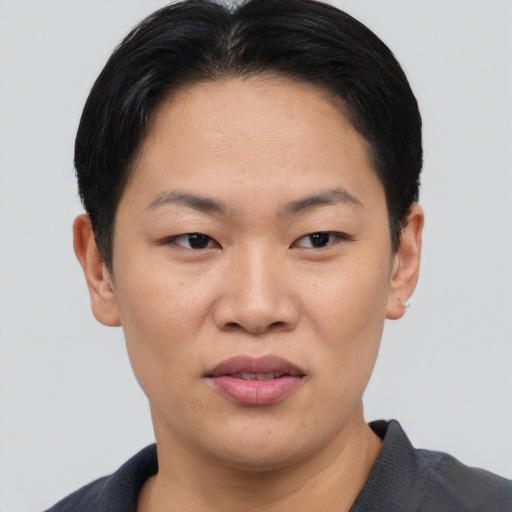 Joyful asian young-adult female with short  black hair and brown eyes