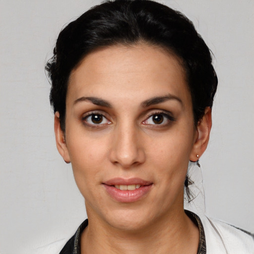 Joyful white young-adult female with short  black hair and brown eyes