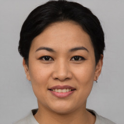 Joyful asian young-adult female with short  black hair and brown eyes