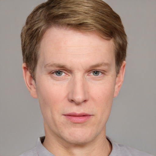 Joyful white adult male with short  brown hair and grey eyes