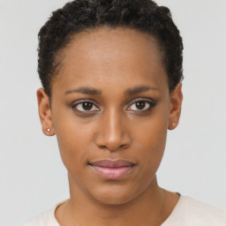 Joyful black young-adult female with short  brown hair and brown eyes